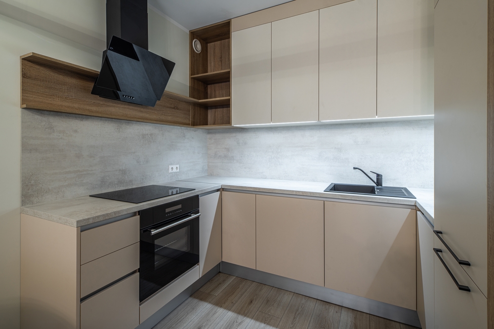 Modern,Interior,Of,Beige,Kitchen,In,Renovated,Apartment.,Oven,And